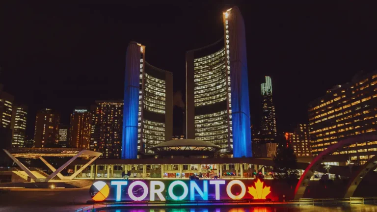 Night view of illuminated Toronto City Hall and sign