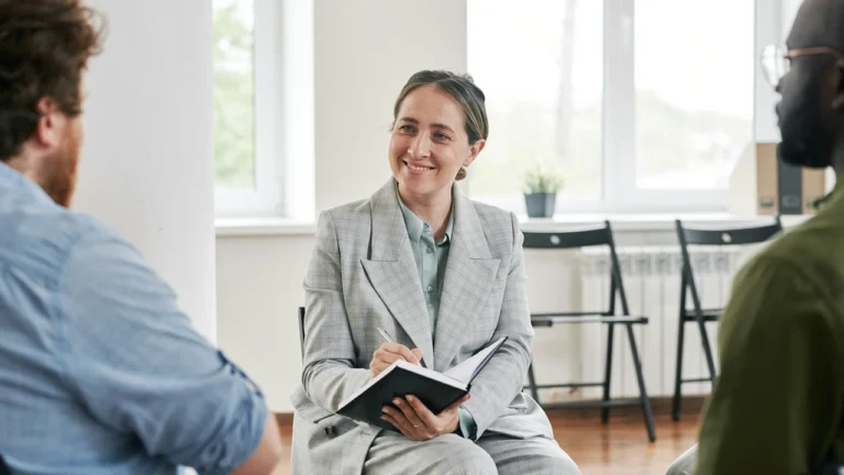 Businesswoman discussing with colleagues in modern office