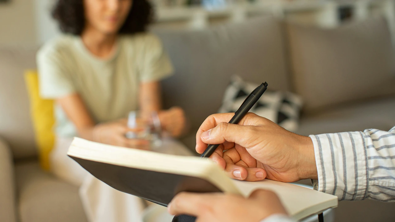 Person taking notes during a home consultation
