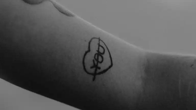 A woman receives a beautifully wrapped gift from someone, symbolizing love and appreciation.