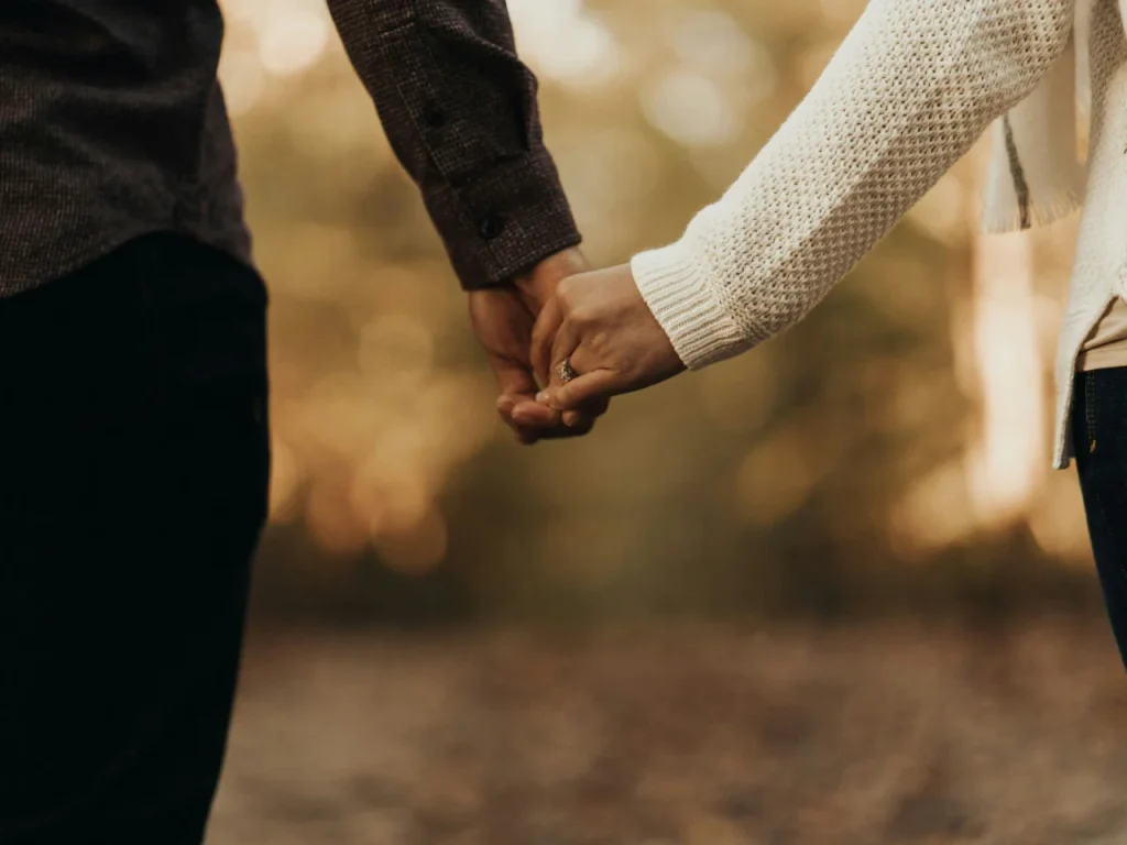 Woman and man holding hands, deciding whether the Gottman Method is right for them