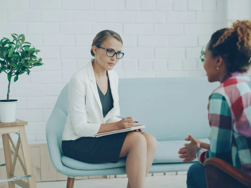 Two women talking in a therapy session about seasonal depression